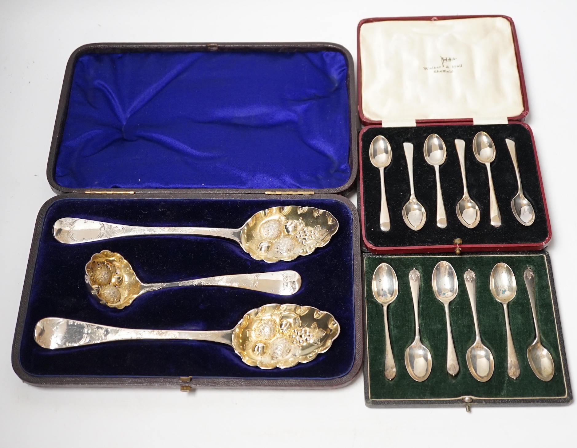 Three assorted cases of silver flatware, including two sets of six silver teaspoons and a 19th matched silver three piece serving and sifter spoon set.